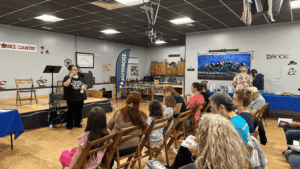 Jessica Dugas reads her latest book There Will Be Hugs to her book signing audience at Dance Country.